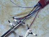 Red and black wires soldered to metal wipers