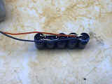 Gray and orange wires soldered to capacitor array